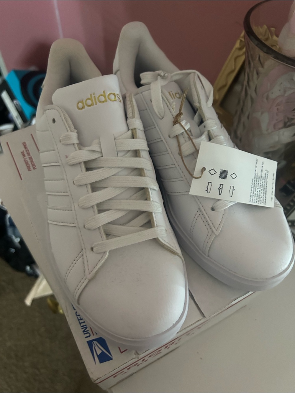 adidas White Low-Top Sneakers with Gold Branding